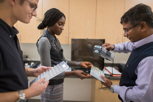 an instructor demonstrates for two students